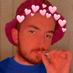 Young Man in Oversized Hat and Shirt with Vaporizer