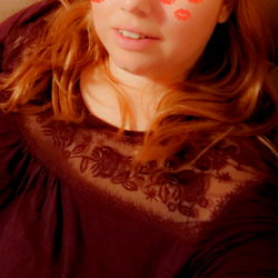 Ambilicious model posing in front of camera with red lipstick