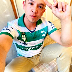 A Man in a Soccer Jersey Taking a Selfie