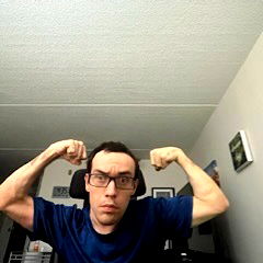 Young man flexing muscles with determination