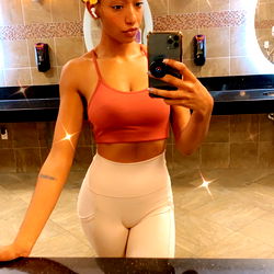 Stylish Model Posing in Mirror at Gym