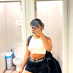 Ash_ in a bathroom selfie with backpack and phone