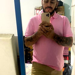 A Man in a Pink Shirt Taking a Mirror Selfie
