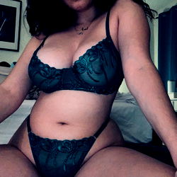 Model in a teal bralette showcasing her curves