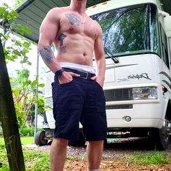 Fit Model Showcasing Ripped Physique in Outdoor Setting