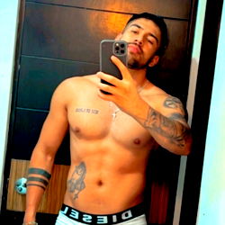 A Fit and Tattooed Model Pose in a Mirror