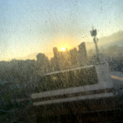 Simoon - Sunset View of the City from a Window