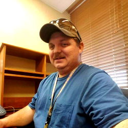 A Man in a Casual Shirt at an Office Desk