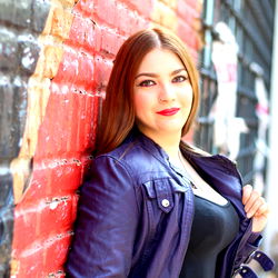 Mexican Model Posing Against Brick Wall