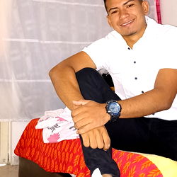 Young Man Sitting on Bed with White Shirt and Smile