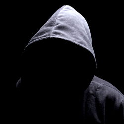 Silhouette of a Hooded Figure in Darkness