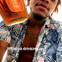 James from Dallas in a Floral Shirt holding a Bottle of Liquor