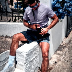 Jjay, Model from England, Casually Posing Against a Blue Wall