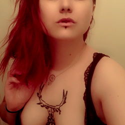 Red-haired woman in corset and lingerie