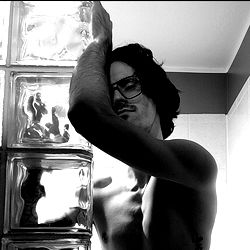 Shirtless Man in Glass Blocks