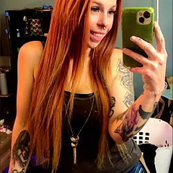 Beee, a stunning model with long red hair and a playful vibe!