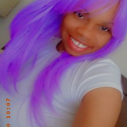 Greensboro, NC-Based OnlyFans Model Godddesss in Purple Wig and White Top