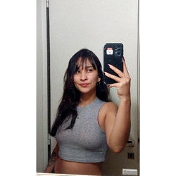 Young Woman Smiling in Bathroom Mirror