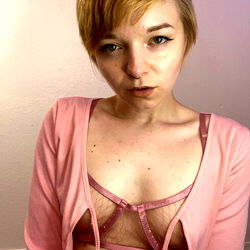 A Young Woman in a Pink Sweater and Lingerie, Striking a Pose