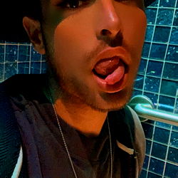 Fashionable Model Alyx/Marcus Showcasing a Stylish Outfit and Playful Expression in Las Vegas