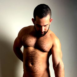 OnlyFans Model Pup Capitan: A Tattooed Stud in an Intimate Studio Shoot