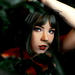 Russia's Annlurine Peeking from Behind a Plant in OnlyFans