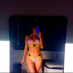 Kati, a model with bikini and crop top fashion, posing confidently for the camera.