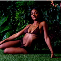 Model JAZMYN on a photoshoot set with plants and foliage