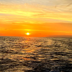A serene sunset at the beach with a view of the ocean