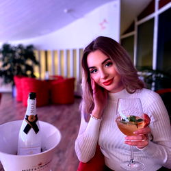 An1sthasia enjoying wine in a stylish setting