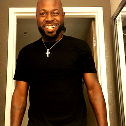 Confident Smiling Man in Black T-Shirt