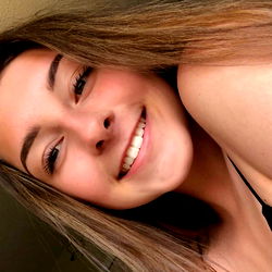 Smiling Woman with Long Hair in a Tank Top