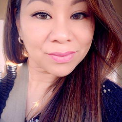 Elaine, a young adult woman with long hair and makeup