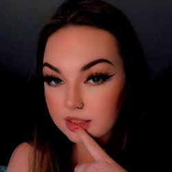 Seductive Model Posing in Fancy Makeup with Finger to Lip