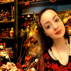 A young lady with red hair posing in a festively decorated room, presumably for OnlyFans.