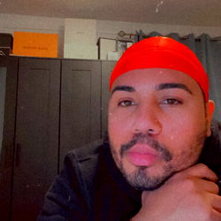 Man in a Red Headband Sitting at a Desk