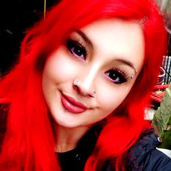 Vivid Red-Haired Individual with Piercings and Gorgeous Makeup