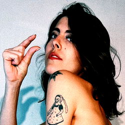 OnlyFans Model Kalia, Striking a Pose in Tattoo-Adorned Space