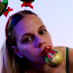 Model in festive holiday attire with party hat and festive props.