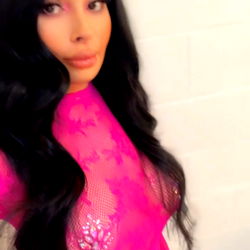 Model in Pink Jumpsuit Poses for Camera