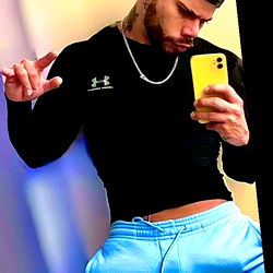 OnlyFans Model AlexxxRxx, Confidently Striking a Pose in Blue Jeans and Tank Top
