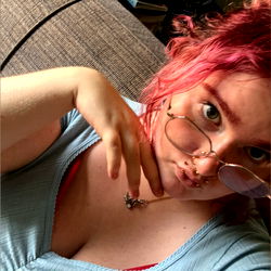 Woman in a Light Blue Shirt Taking a Selfie