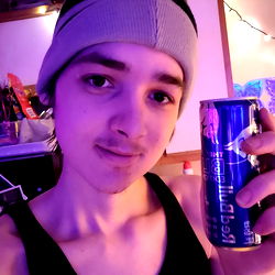 Enthusiastic Young Adult Holding Red Bull Energy Drink