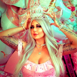 A Female Model Poses in a Party Themed Shoot with Fluffy Pink Details