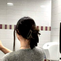 A Woman Checking Herself in a Mirror