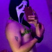 Model in Erotic Costume Taking Selfie