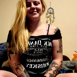 OnlyFans Model XxArdamisxx, Sitting in a Tattoo-Covered Room