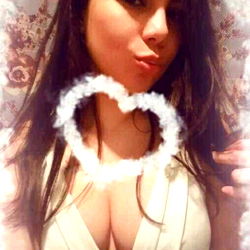 Atti, OnlyFans Model Posing in Front of Flower Wall with Heart Frame