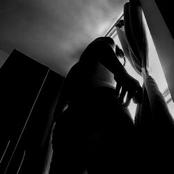 An intimate moment captured in a dark room with silhouetted figures