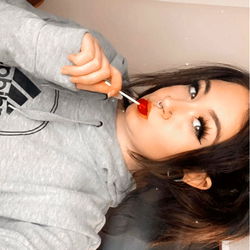 A Young Woman Enjoying a Moment of Personal Style with Her Favorite Candy